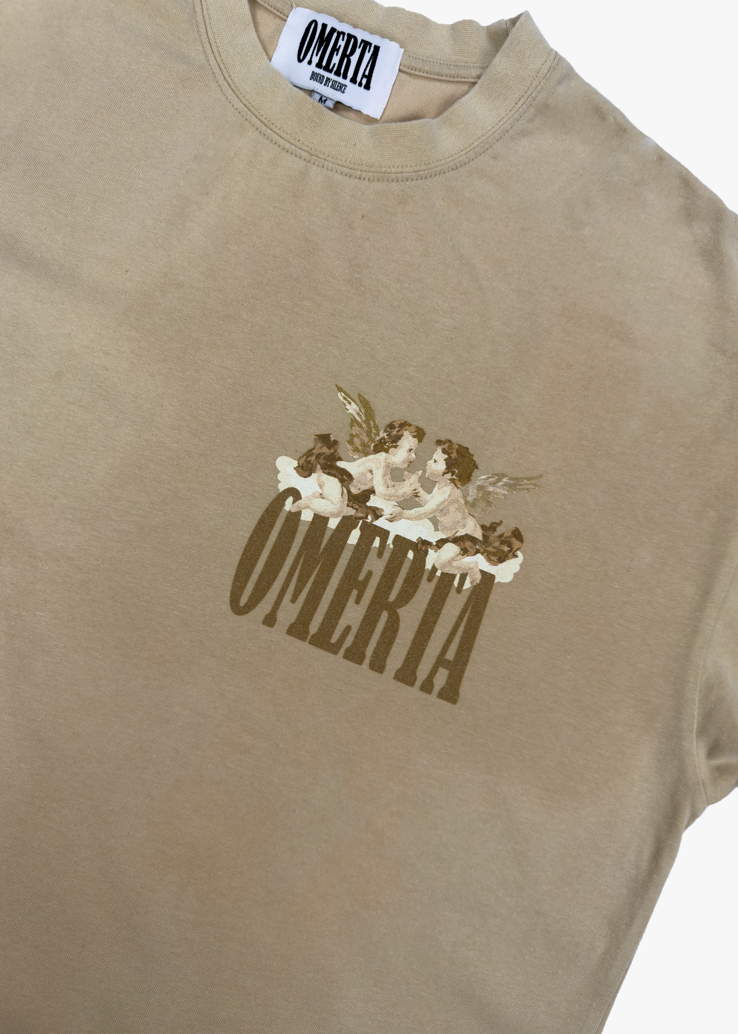 Front of the Angel's Haven Tee by OMERTA with cherub details near the logo.
