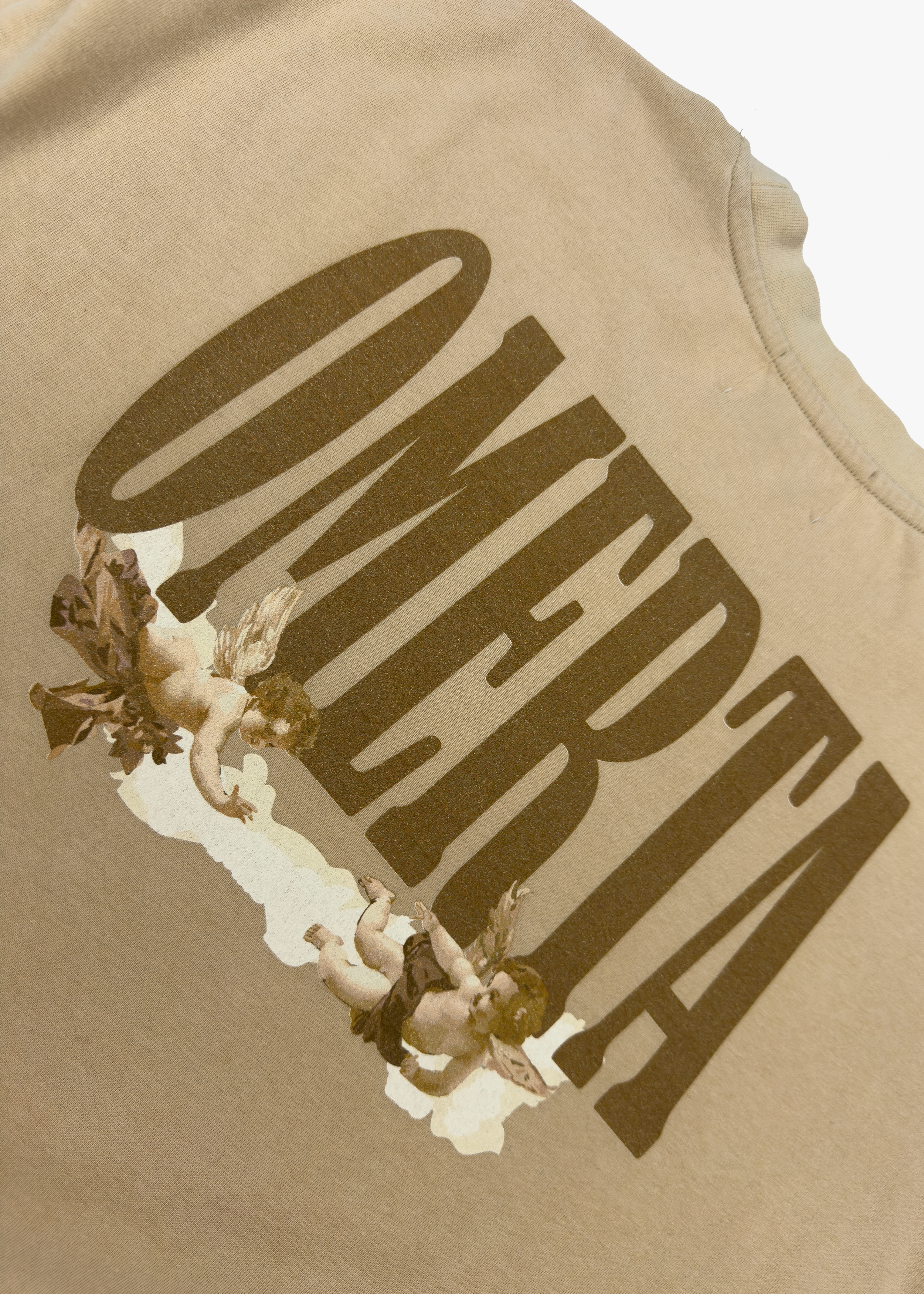 Close-up of the Omerta logo and cherub artwork on the back of the Angel's Haven Tee by OMERTA.